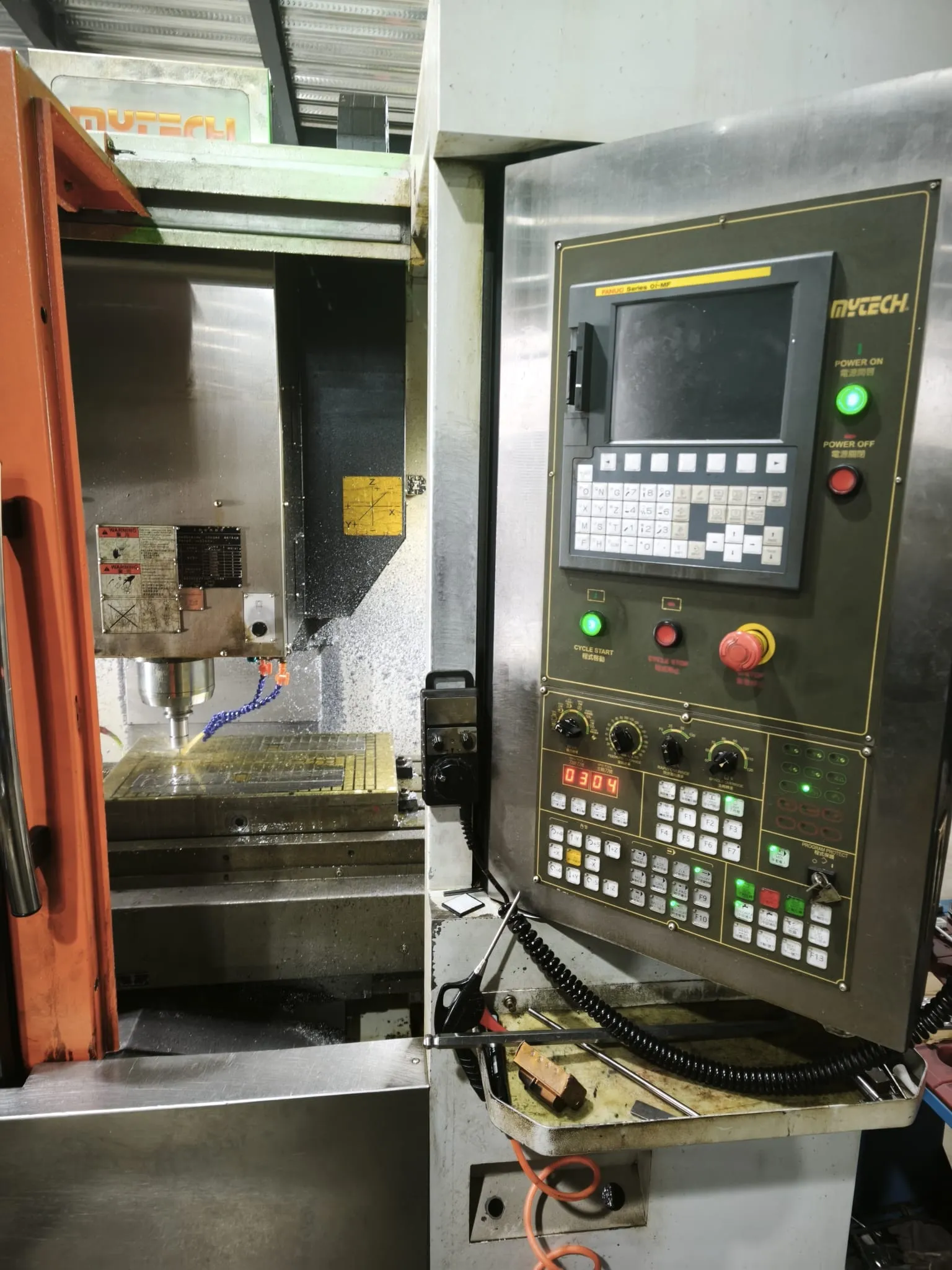 CNC control panel beside the machining area