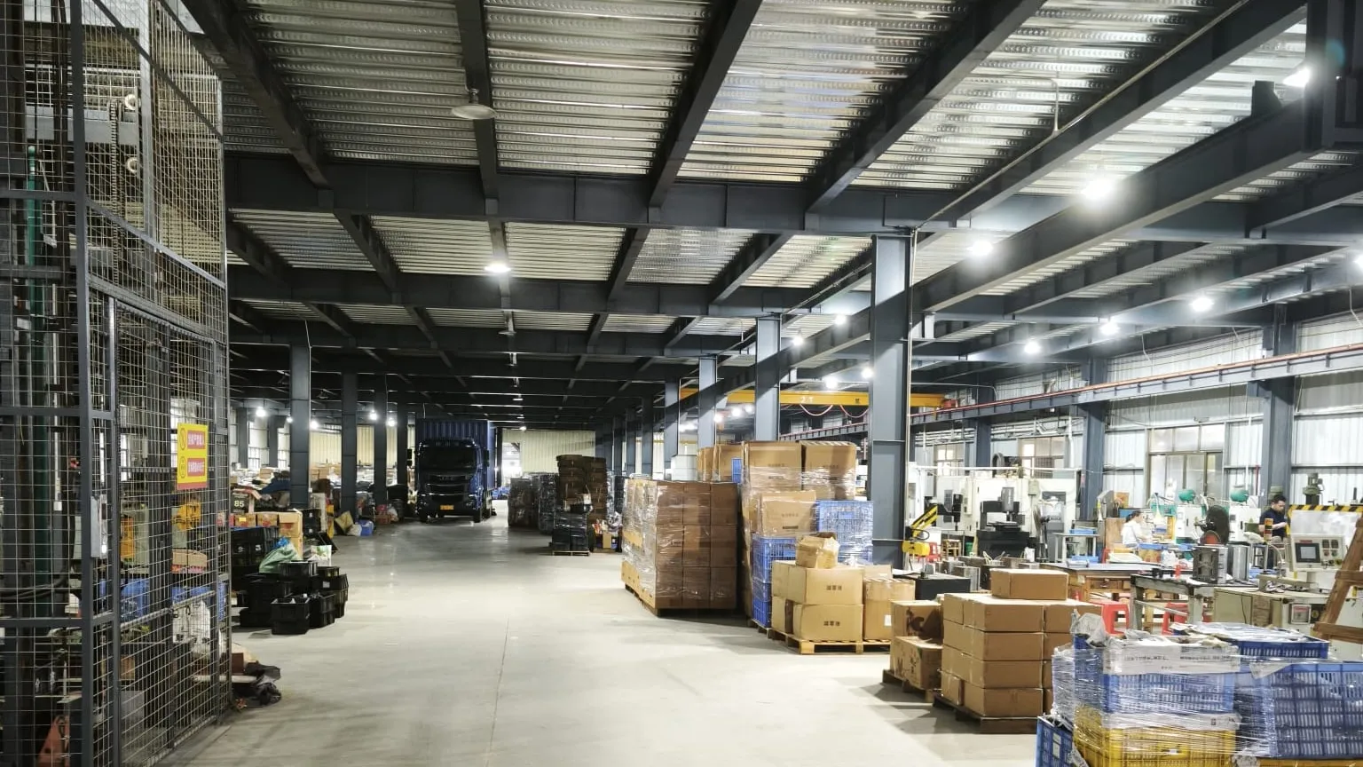 Wide view of the main factory hall with staged cartons and production areas