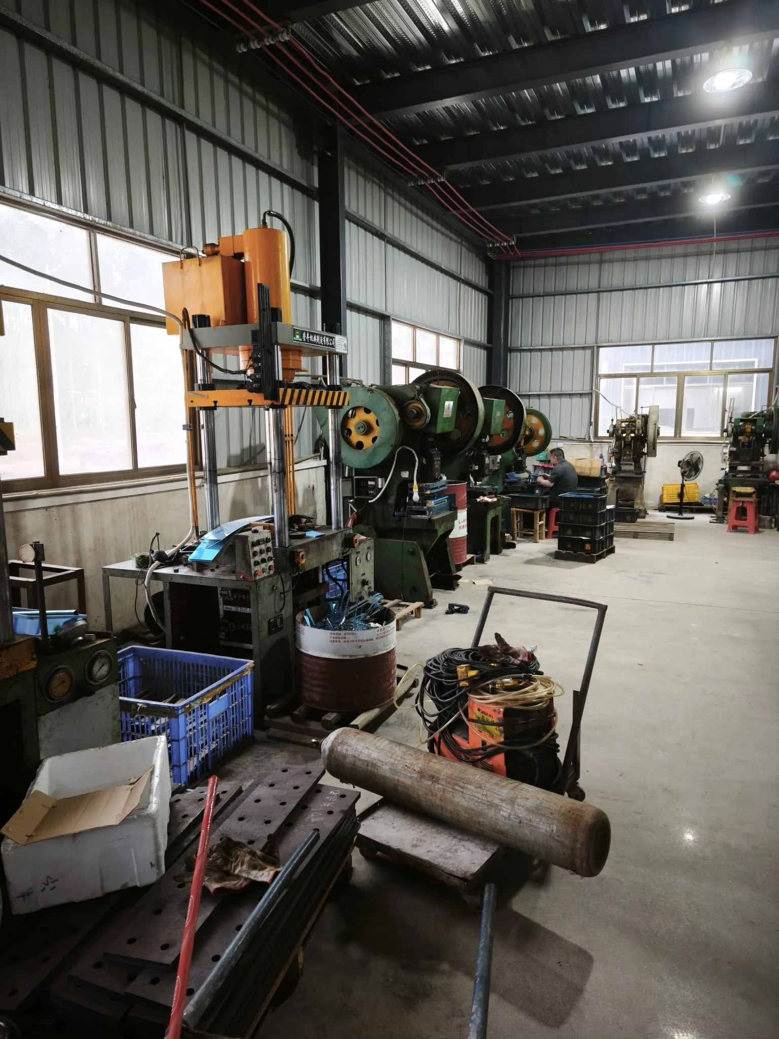 Hydraulic and mechanical presses along the windows of the pressing bay
