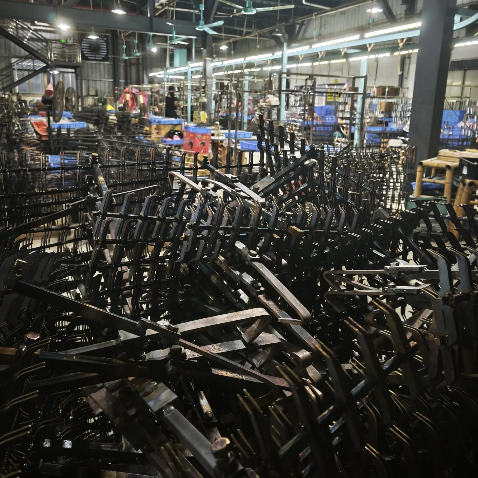Empty electroplating racks stacked in the factory, ready to be loaded with parts
