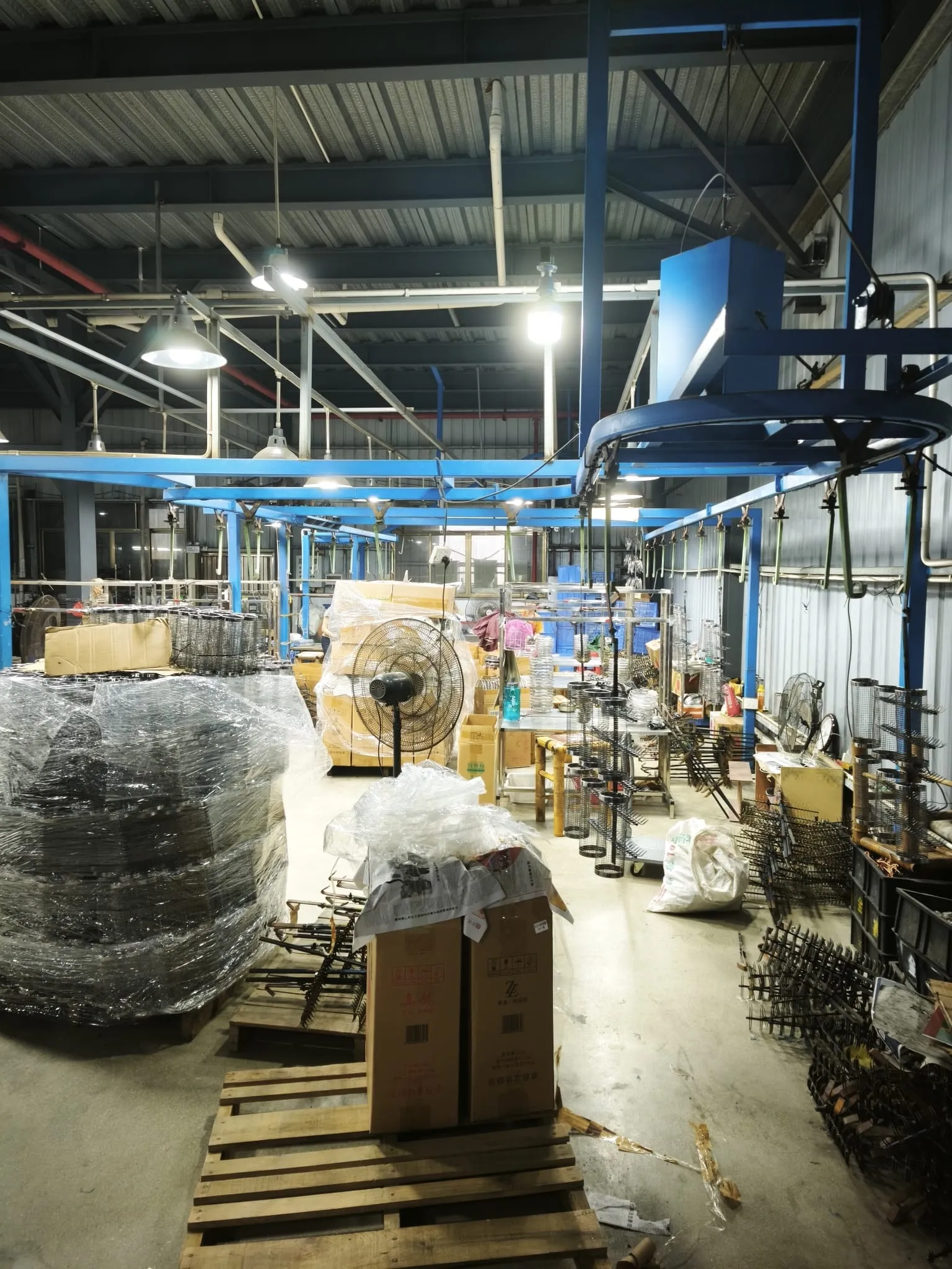 Overhead conveyor and wire parts on pallets in the wire products area