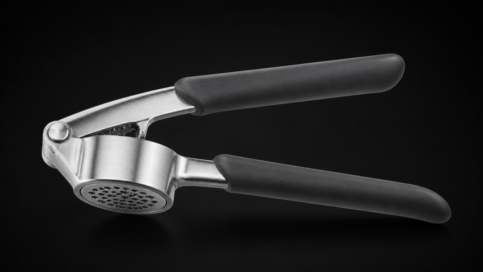 Garlic Press product photograph on a dark studio background