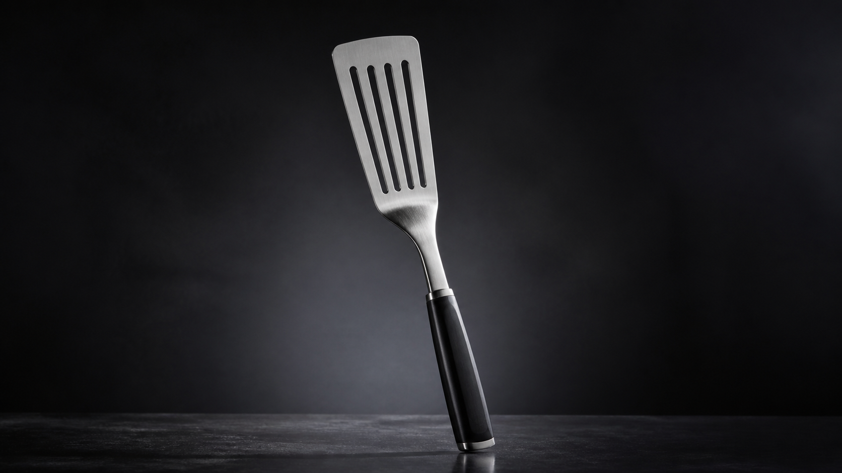 Slotted Turner Spatula product photograph on a dark studio background